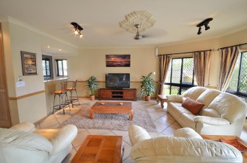 Living room with flat screen TV and wet bar